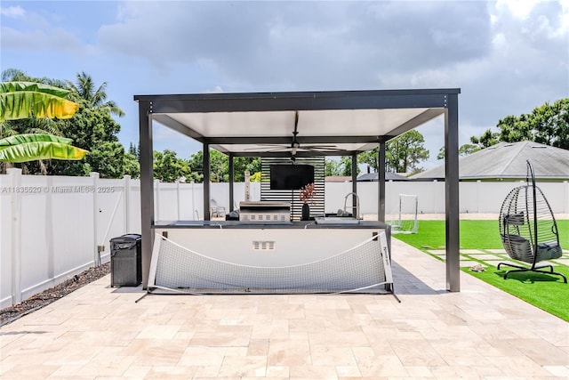 1149 SE Sandia Dr, Port St Lucie, FL 34983 - fenced backyard with exterior kitchen, a gazebo, a patio area, and ceiling fan