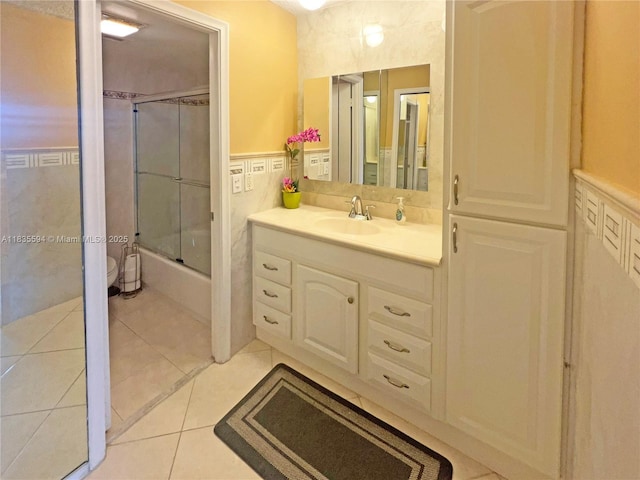 2000 S Ocean Blvd Unit 16P, Lauderdale By The Sea, FL 33062 - full bath with vanity, enclosed tub / shower combo, tile walls, tile patterned flooring, and wainscoting