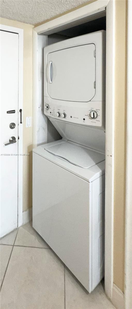 2000 S Ocean Blvd Unit 16P, Lauderdale By The Sea, FL 33062 - laundry area featuring stacked washer / dryer and light tile patterned flooring