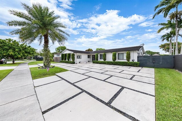 10321 SW 102nd Ave, Miami, FL 33176 - view of front of home with a gate, driveway, and stucco siding