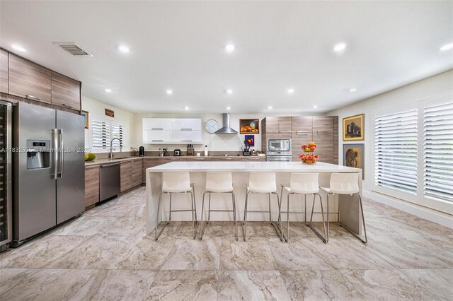 10321 SW 102nd Ave, Miami, FL 33176 - kitchen with modern cabinets, stainless steel appliances, wall chimney exhaust hood, a breakfast bar area, and recessed lighting