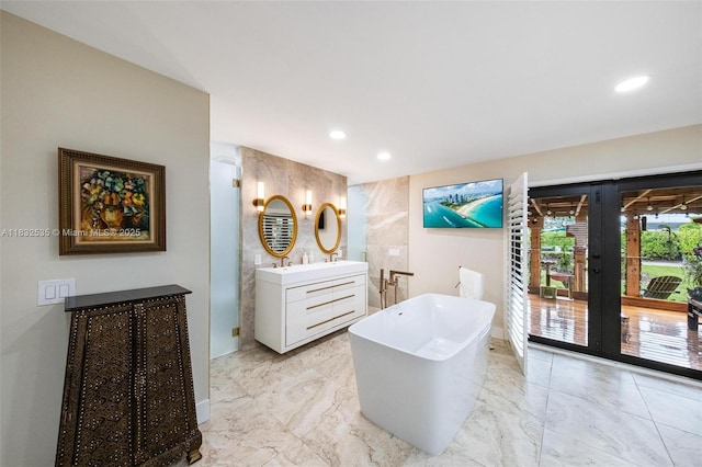 10321 SW 102nd Ave, Miami, FL 33176 - full bathroom with vanity, french doors, a freestanding bath, recessed lighting, and marble look tiles