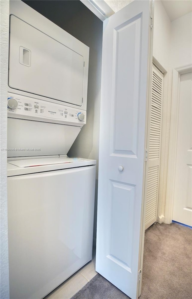 1589 SE 26th Rd, Homestead, FL 33035 - washroom featuring stacked washer and clothes dryer and light colored carpet