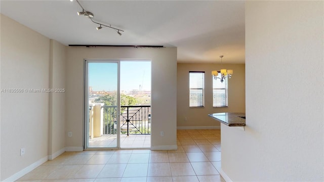 9021 SW 94th St Unit 604, Miami, FL 33176 - empty room with a chandelier, light tile patterned floors, and track lighting