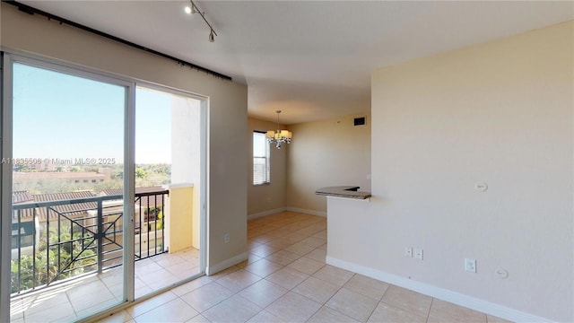 9021 SW 94th St Unit 604, Miami, FL 33176 - unfurnished room featuring a chandelier, light tile patterned floors, and track lighting