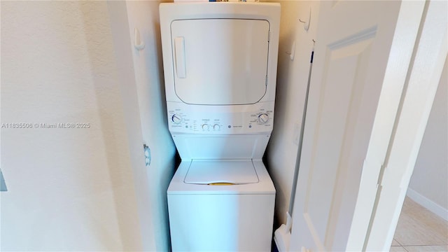 9021 SW 94th St Unit 604, Miami, FL 33176 - laundry area with stacked washing machine and dryer and light tile patterned floors
