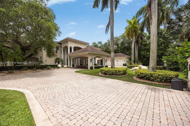 7245 SW 104th St, Pinecrest, FL 33156 - mediterranean / spanish house featuring curved driveway and stucco siding