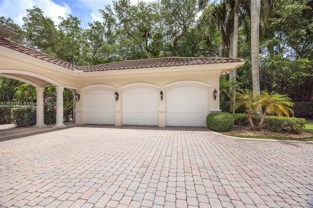 7245 SW 104th St, Pinecrest, FL 33156 - garage featuring decorative driveway and view of wooded area