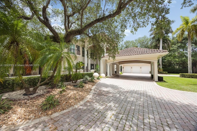 7245 SW 104th St, Pinecrest, FL 33156 - mediterranean / spanish home with decorative driveway, an attached garage, a tiled roof, and stucco siding