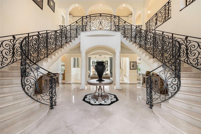 7245 SW 104th St, Pinecrest, FL 33156 - entrance foyer featuring ornate columns, a high ceiling, stairs, and arched walkways