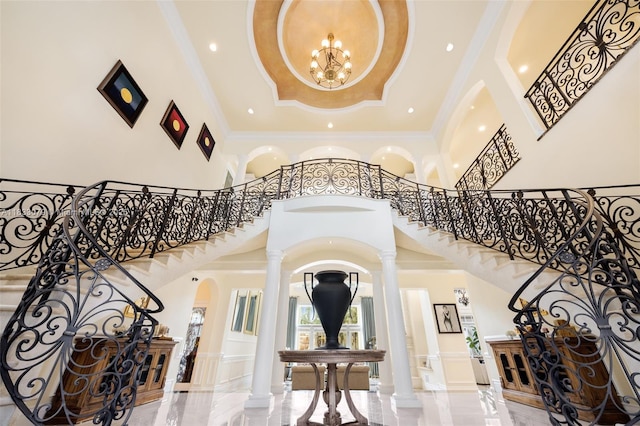 7245 SW 104th St, Pinecrest, FL 33156 - entryway with arched walkways, stairs, a towering ceiling, crown molding, and recessed lighting