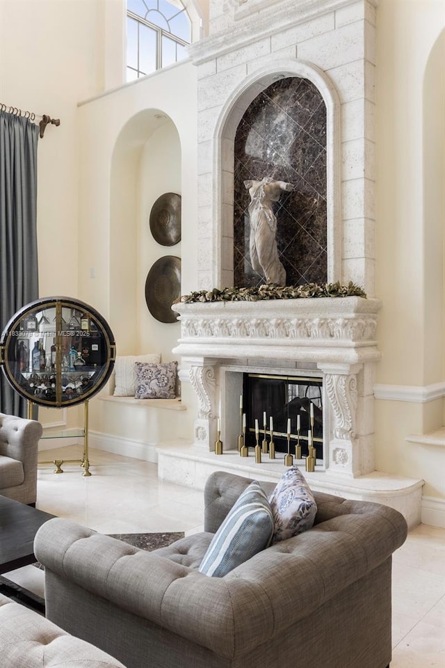 7245 SW 104th St, Pinecrest, FL 33156 - living area featuring a glass covered fireplace, a towering ceiling, and arched walkways