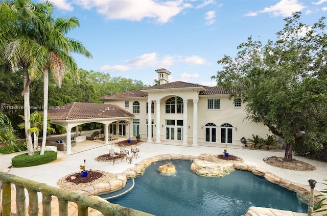 7245 SW 104th St, Pinecrest, FL 33156 - back of property with french doors, a gazebo, a tile roof, an outdoor pool, and a patio area