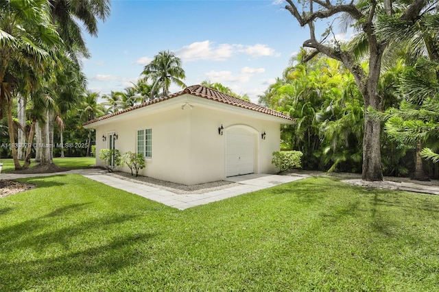 7245 SW 104th St, Pinecrest, FL 33156 - view of home's exterior featuring a tiled roof, stucco siding, a yard, and a garage
