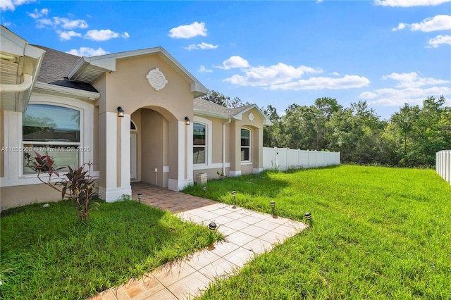 334 Colony St, Kissimmee, FL 34758 - view of exterior entry with stucco siding and roof with shingles