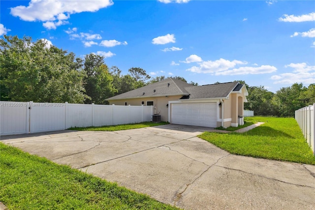 334 Colony St, Kissimmee, FL 34758 - view of home's exterior featuring stucco siding, driveway, and an attached garage