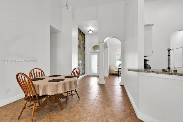 334 Colony St, Kissimmee, FL 34758 - dining area with a towering ceiling, decorative columns, arched walkways, and light tile patterned floors