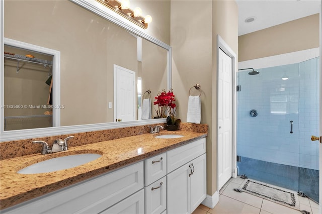 334 Colony St, Kissimmee, FL 34758 - full bathroom with a shower stall, tile patterned floors, double vanity, and a walk in closet