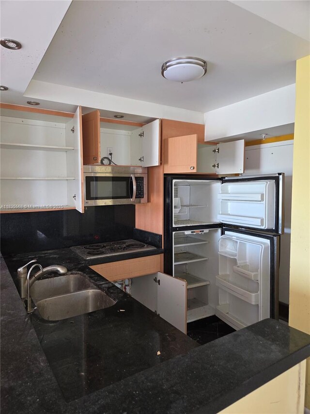 400 Kings Point Dr Unit 401, Sunny Isles Beach, FL 33160 - kitchen with stainless steel microwave, open shelves, electric cooktop, fridge, and dark stone countertops