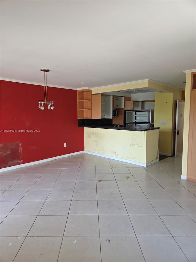 400 Kings Point Dr Unit 401, Sunny Isles Beach, FL 33160 - kitchen featuring dark countertops, light tile patterned floors, stainless steel appliances, open shelves, and ornamental molding