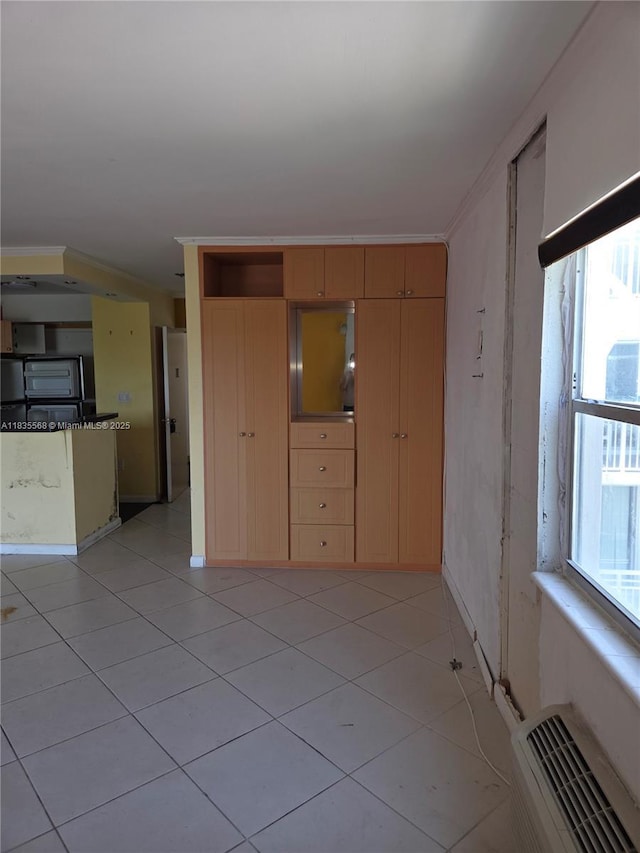 400 Kings Point Dr Unit 401, Sunny Isles Beach, FL 33160 - unfurnished living room featuring light tile patterned floors and ornamental molding