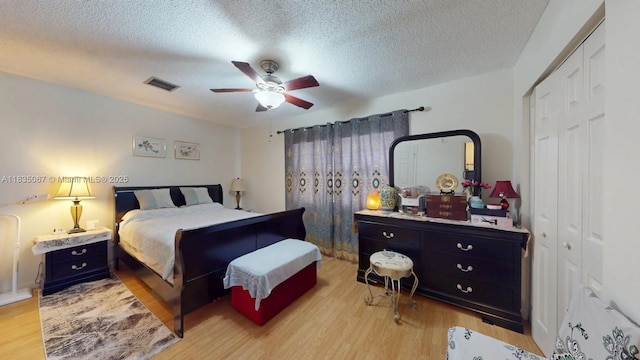 15 Laredo Pl Unit 2-7, Davie, FL 33324 - bedroom featuring light wood-style floors, a textured ceiling, and ceiling fan