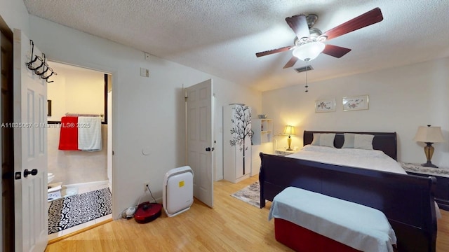 15 Laredo Pl Unit 2-7, Davie, FL 33324 - bedroom featuring light wood-type flooring, a textured ceiling, and ceiling fan