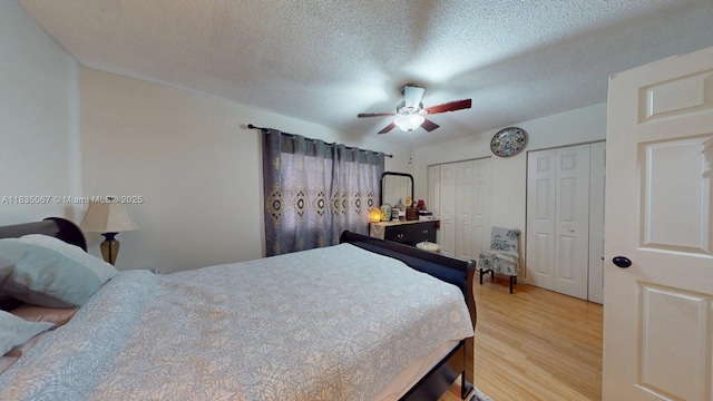 15 Laredo Pl Unit 2-7, Davie, FL 33324 - bedroom featuring multiple closets, wood finished floors, a textured ceiling, and a ceiling fan