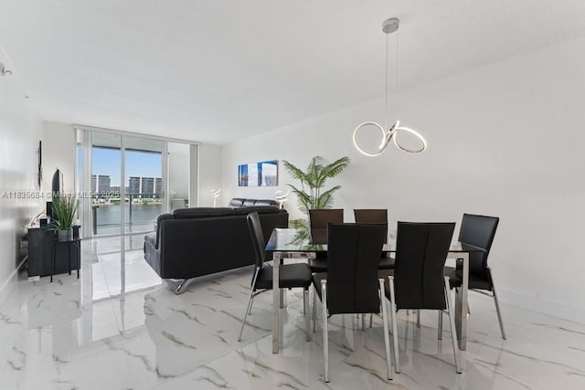18100 N Bay Rd Unit 1108, Sunny Isles Beach, FL 33160 - dining area featuring a wall of windows, a chandelier, and marble finish floors