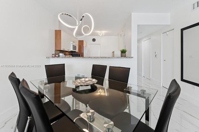 18100 N Bay Rd Unit 1108, Sunny Isles Beach, FL 33160 - dining room featuring marble look tile flooring and baseboards