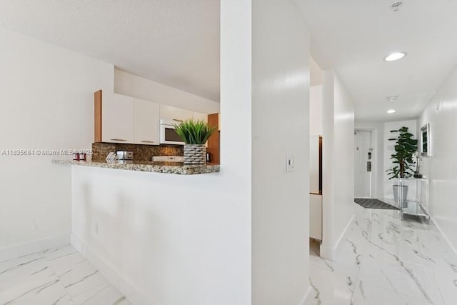 18100 N Bay Rd Unit 1108, Sunny Isles Beach, FL 33160 - hall featuring light marble finish floors and recessed lighting