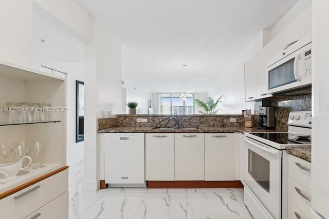 18100 N Bay Rd Unit 1108, Sunny Isles Beach, FL 33160 - kitchen with white appliances, white cabinets, dark stone counters, and backsplash