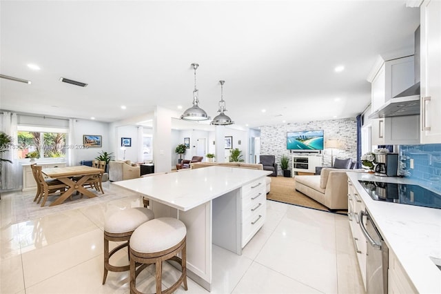 9720 SW 140th St, Miami, FL 33176 - kitchen with black electric stovetop, open floor plan, light tile patterned floors, a center island, and wall chimney range hood