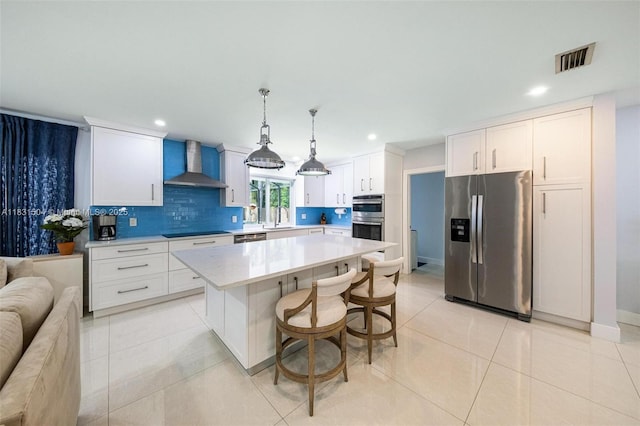9720 SW 140th St, Miami, FL 33176 - kitchen featuring appliances with stainless steel finishes, wall chimney range hood, light countertops, open floor plan, and backsplash