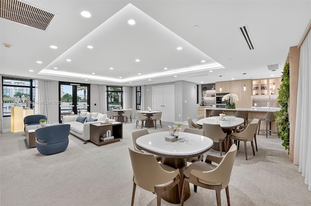 200 E Palmetto Park Rd Unit 714, Boca Raton, FL 33432 - dining room featuring a raised ceiling, light carpet, and recessed lighting