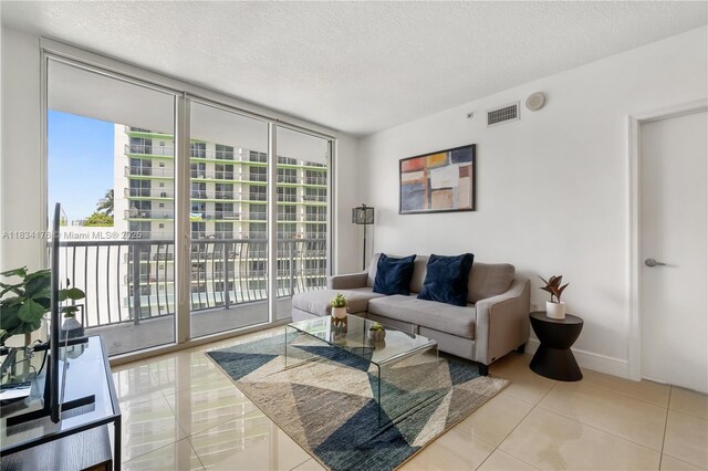1750 N Bayshore Dr Unit 1611, Miami, FL 33132 - tiled living area with expansive windows, healthy amount of natural light, and a textured ceiling