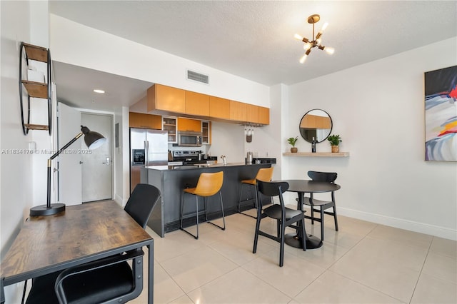 1750 N Bayshore Dr Unit 1611, Miami, FL 33132 - kitchen featuring appliances with stainless steel finishes, brown cabinetry, a peninsula, glass insert cabinets, and a breakfast bar