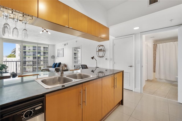 1750 N Bayshore Dr Unit 1611, Miami, FL 33132 - kitchen with light tile patterned flooring, dishwashing machine, dark countertops, and open floor plan