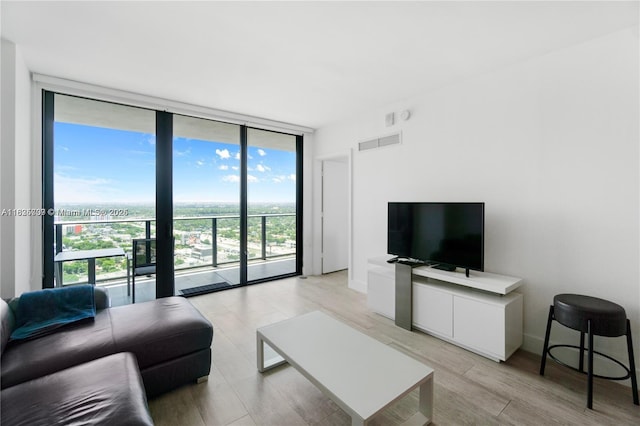 121 NE 34th St Unit 3012, Miami, FL 33137 - living area with expansive windows and light wood-type flooring