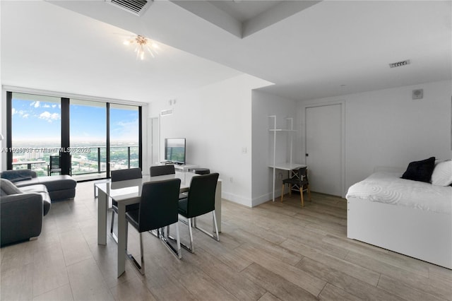 121 NE 34th St Unit 3012, Miami, FL 33137 - dining area with a wall of windows and light wood-type flooring