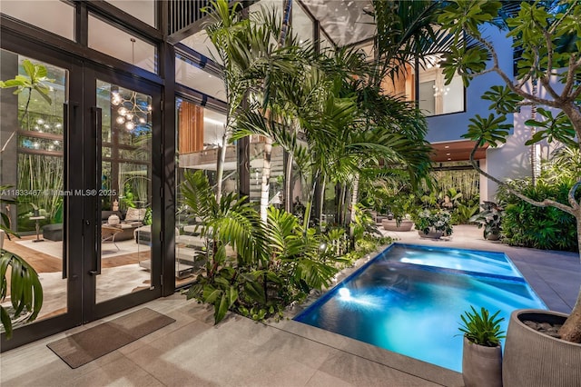 3910 Battersea Rd, Miami, FL 33133 - view of swimming pool with french doors, a pool with connected hot tub, and a patio area