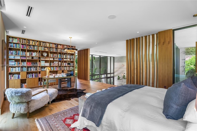 3910 Battersea Rd, Miami, FL 33133 - bedroom featuring expansive windows, multiple windows, wood finished floors, and access to outside