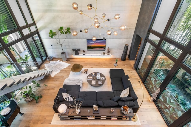 3910 Battersea Rd, Miami, FL 33133 - living room with hardwood / wood-style floors, a chandelier, and a high ceiling