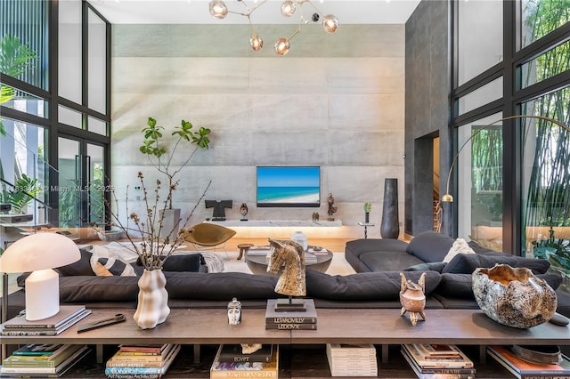 3910 Battersea Rd, Miami, FL 33133 - living area with a high ceiling, a wall of windows, and a chandelier
