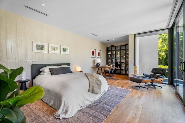 3910 Battersea Rd, Miami, FL 33133 - bedroom featuring hardwood / wood-style floors, multiple windows, and expansive windows