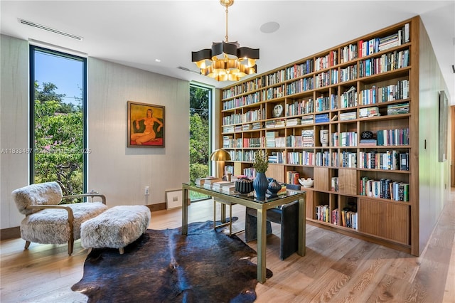 3910 Battersea Rd, Miami, FL 33133 - office space with wood finished floors, a chandelier, and bookshelves