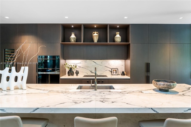 3910 Battersea Rd, Miami, FL 33133 - kitchen with light stone countertops, decorative backsplash, open shelves, and modern cabinets