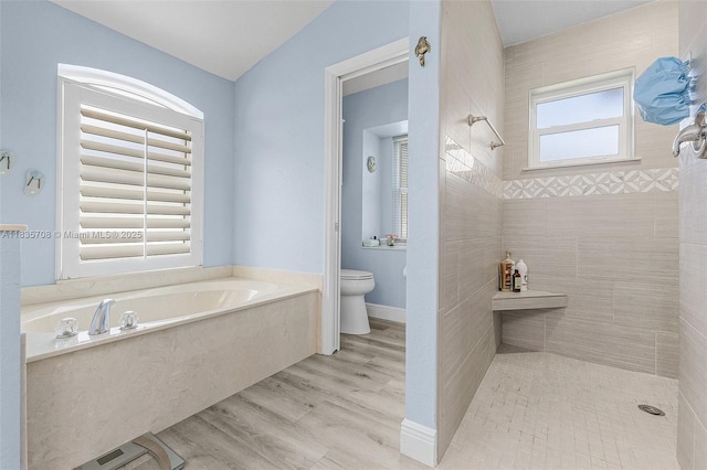 7130 Scarlet Sage Ct, Punta Gorda, FL 33955 - bathroom with a garden tub, tiled shower, and wood finished floors