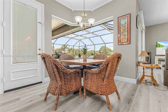 7130 Scarlet Sage Ct, Punta Gorda, FL 33955 - dining area with wood finished floors, a chandelier, and crown molding
