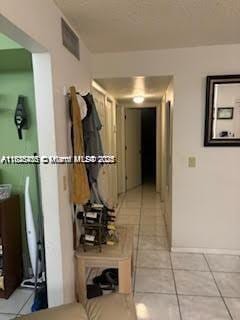 1001 Green Pine Blvd Unit H2, West Palm Beach, FL 33409 - hallway with light tile patterned floors